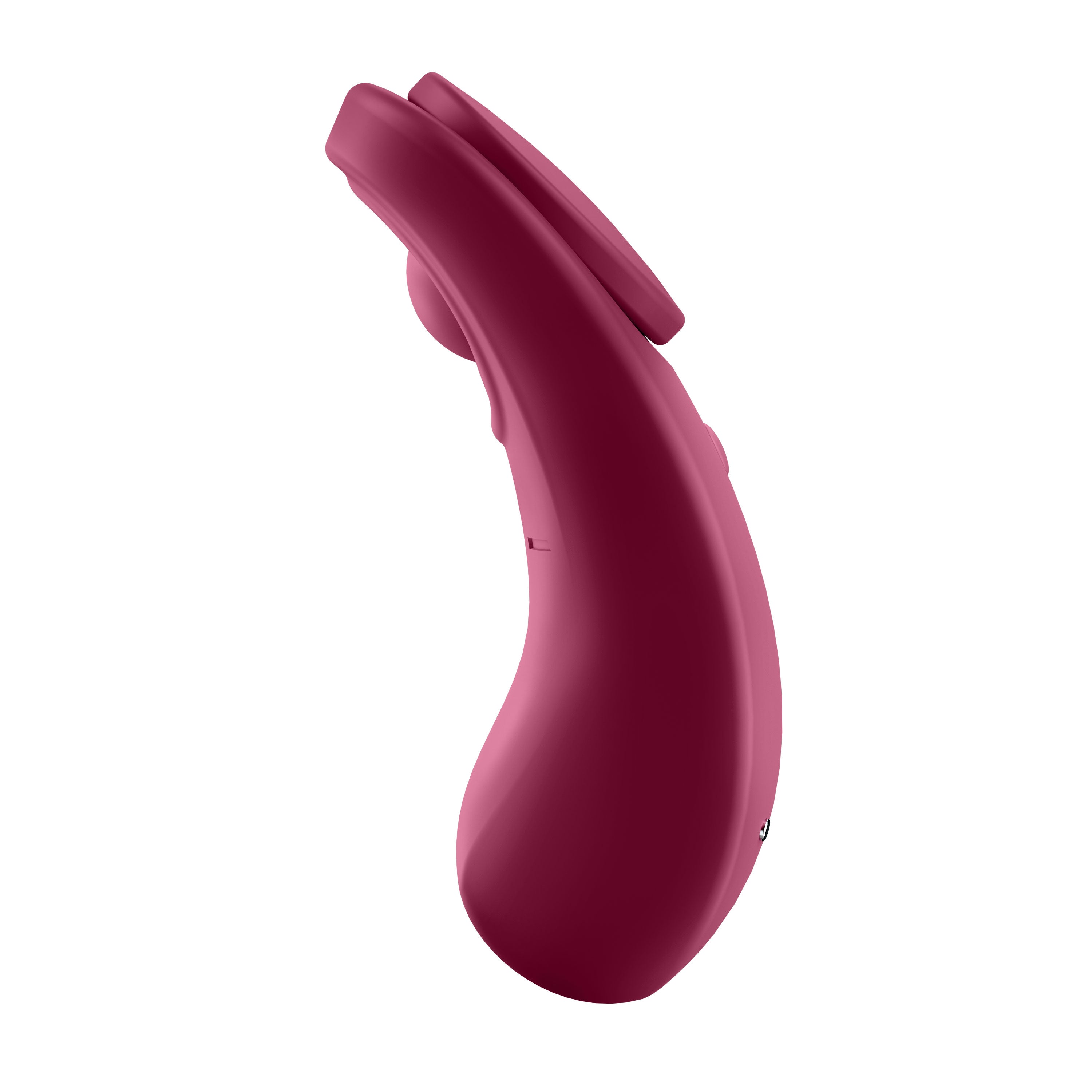 A profile shot of the berry-red magnetic massager, highlighting its slim, tapered silhouette designed for Contoured Hands-Free Comfort and a low-profile fit under clothing.
