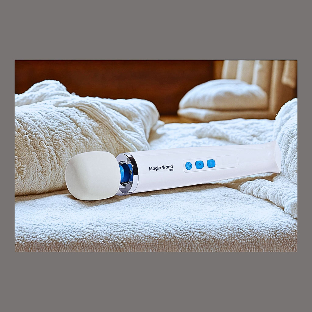 A white Magic Wand Mini wellness device resting on a stack of towels. Showing adaptive mobility comfort.