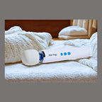 A white Magic Wand Mini wellness device resting on a stack of towels. Showing adaptive mobility comfort.