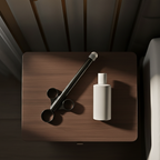 Adaptive intimacy applicator in black resting on a bedside stand for limited mobility.