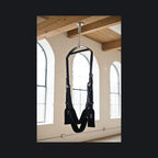 Adaptive mobility suspension swing in a sunlit loft sanctuary for joint pressure relief. 