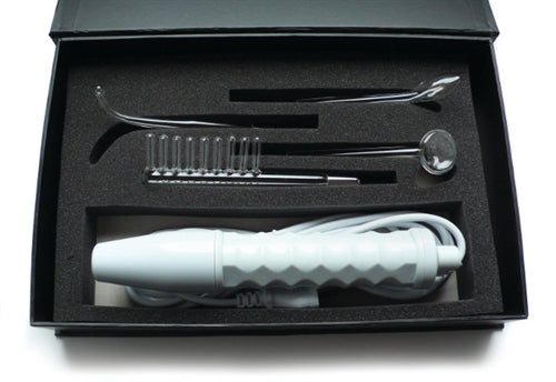 An image of the Neon Pulse Wellness Kit placed in a black box with the stimulator and glass attachments placed securely in foam insets. This joint-friendly electro-stimulation device has a noise level of ~65-75 dBA (Tattoo Gun / Electric Shaver).