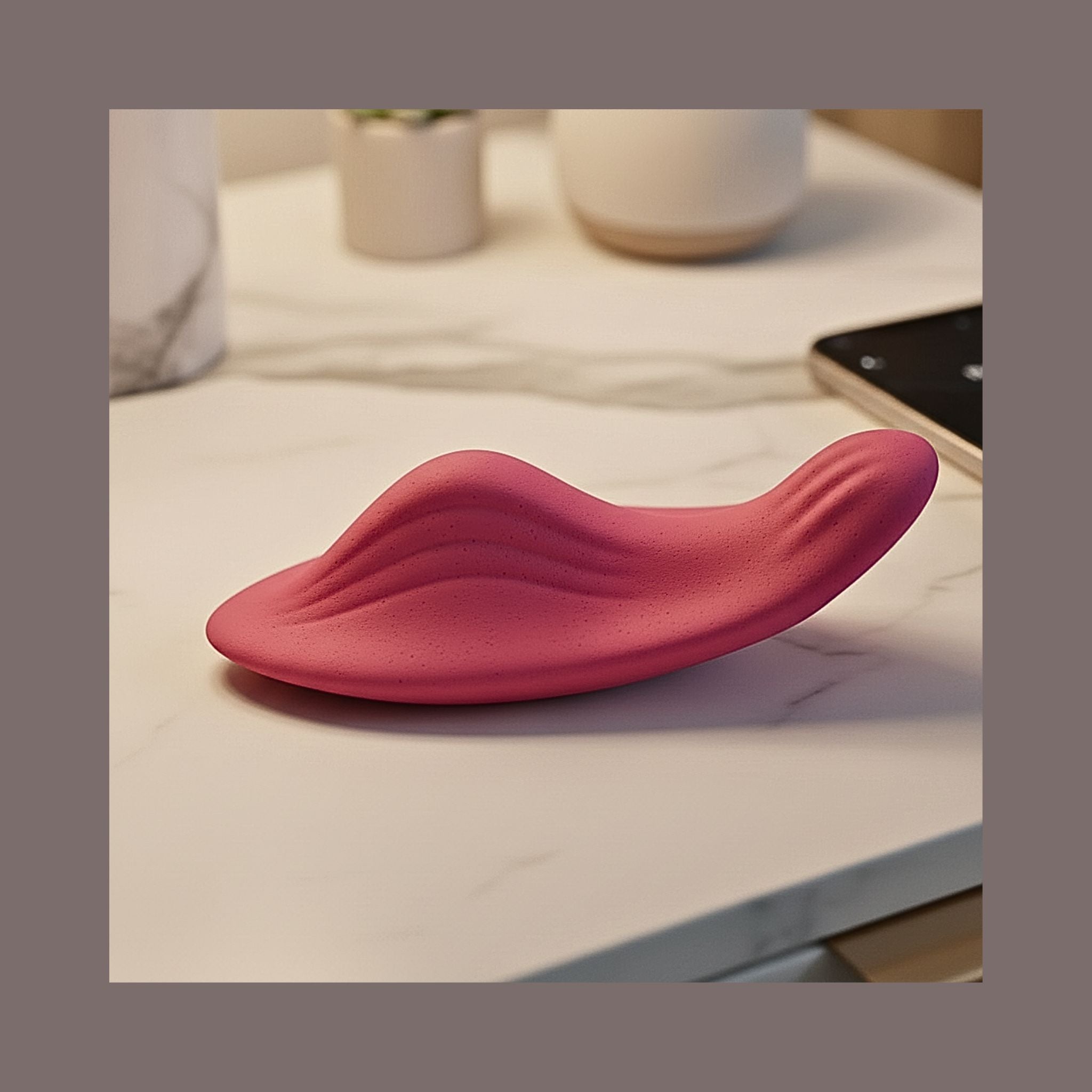 App-controlled wearable wellness device close-up detailing soft pink silicone texture.