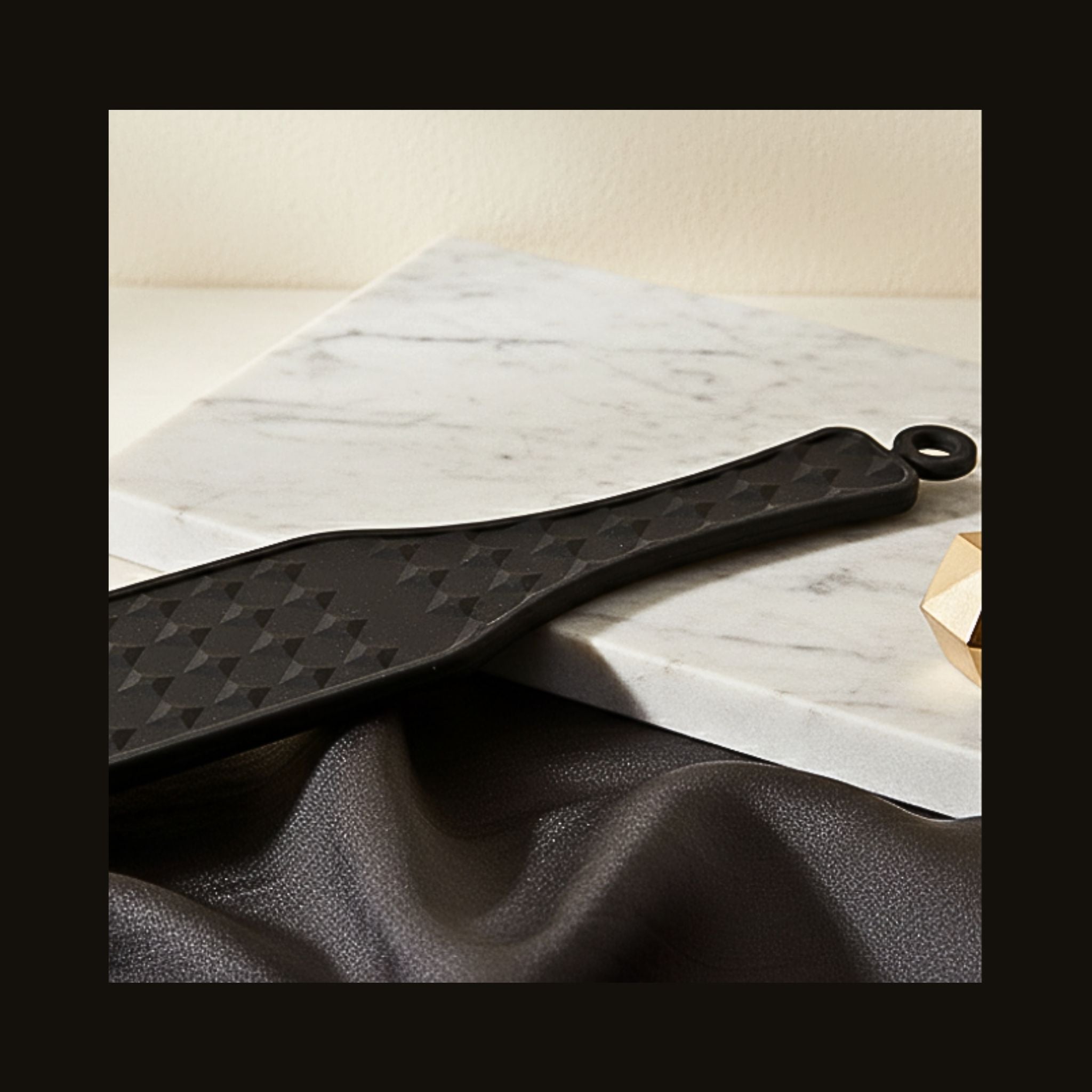 Close-up of Matte black silicone sensory paddle with diamond texture with medical-grade silicone.