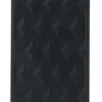 Close-up of raised diamond texture pattern on matte black medical-grade silicone paddle