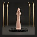 Ergonomic hands-free dilation tool displayed on a black marble plinth for pelvic wellness.