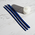 Flexible silicone urethral trainers in blue resting on a white marble shelf for pelvic health.