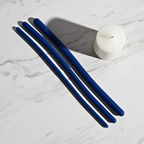 Flexible silicone urethral trainers in blue resting on a white marble shelf for pelvic health.