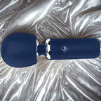 Give Into Me Wellness Wand for Flexible Percussive Care, shown in deep blue on a luxury white and gold brocade bedspread, highlighting its Ergonomic Stability Grip and flexible neck.