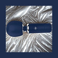 Give Into Me Wellness Wand for Flexible Percussive Care, shown on a luxury bedspread, highlighting its Ergonomic Stability Grip and flexible neck.
