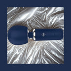 Give Into Me Wellness Wand for Flexible Percussive Care, shown on a luxury bedspread, highlighting its Ergonomic Stability Grip and flexible neck.