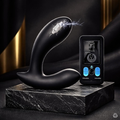 Inclusive prostate wellness massager in black silicone on a marble plinth for pelvic health.