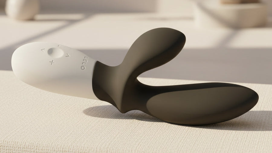 Lelo Loki Wave massager on textured surface and a close-p of the easy-to-grip, ergonomic handle for thumb and wrist joint ease.