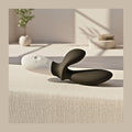 Lelo Loki Wave massager on textured surface with an easy-to-grip, ergonomic handle for thumb and wrist joint ease.