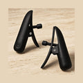 Matte black adjustable sensory clamps on a stone surface. These neuro-inclusive clamps are IPX7 waterproof.