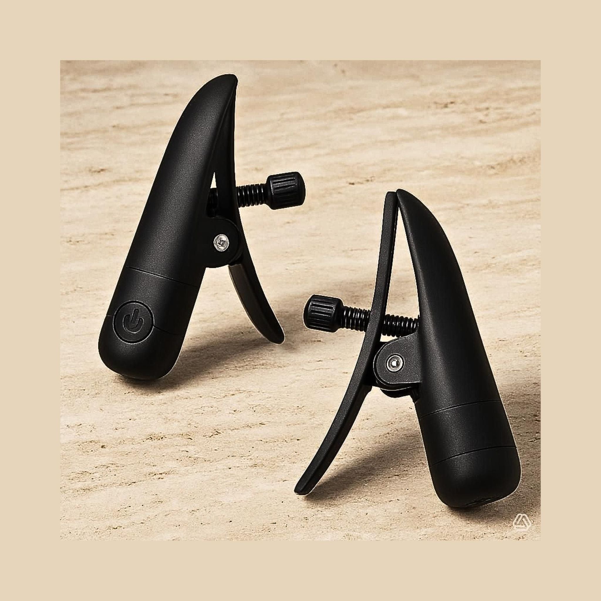 Matte black adjustable sensory clamps on a stone surface. These neuro-inclusive clamps are IPX7 waterproof.