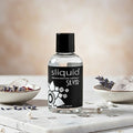 Sliquid Naturals Premium Silicone Glide  4.2 fl. oz bottle on marble for long-lasting skin-safe support.