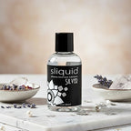 Sliquid Naturals Premium Silicone Glide  4.2 fl. oz bottle on marble for long-lasting skin-safe support.