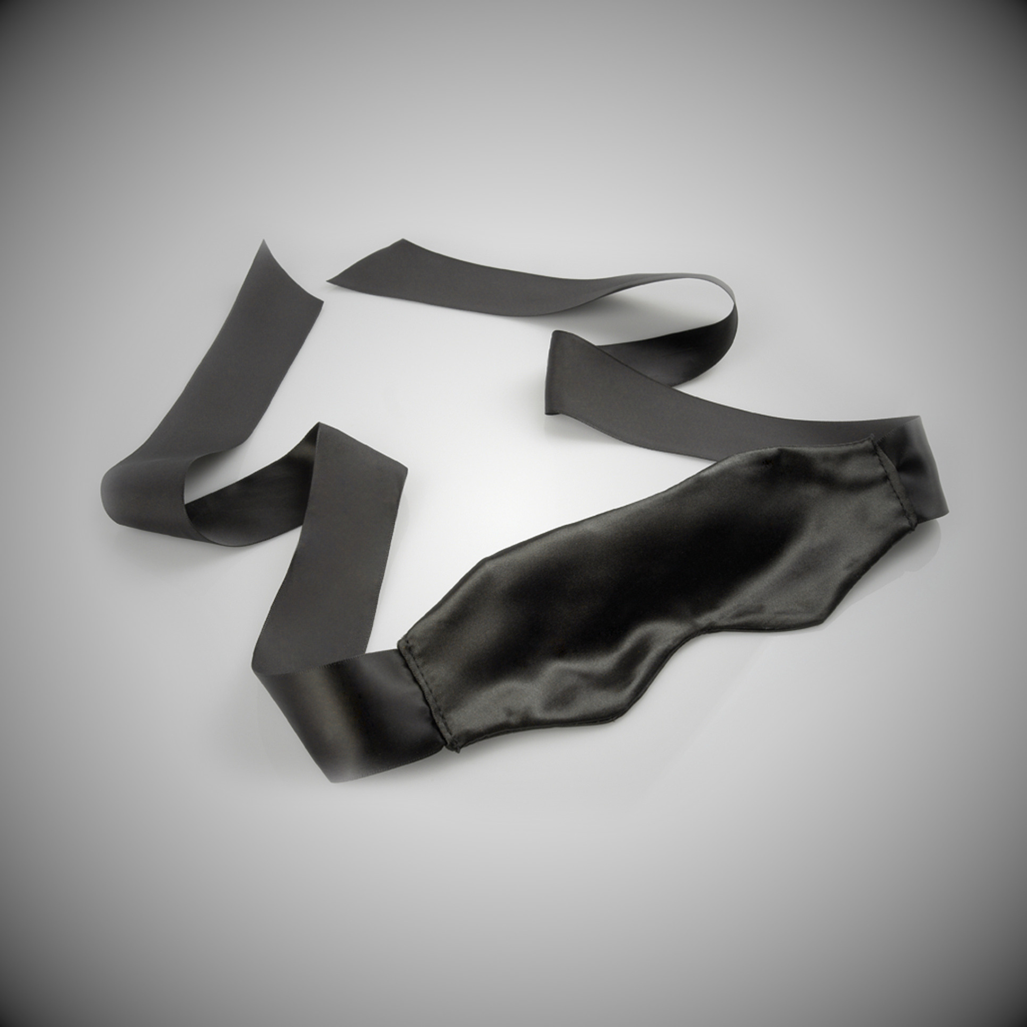Soft black satin blindfold designed for sensory wellness and intimate neuro-inclusive connection.